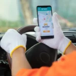 Taxi Service in Trivandrum photo of a taxi driver from keralacabs looking for a new booking received on mobile phone for taxi service in trivandrum